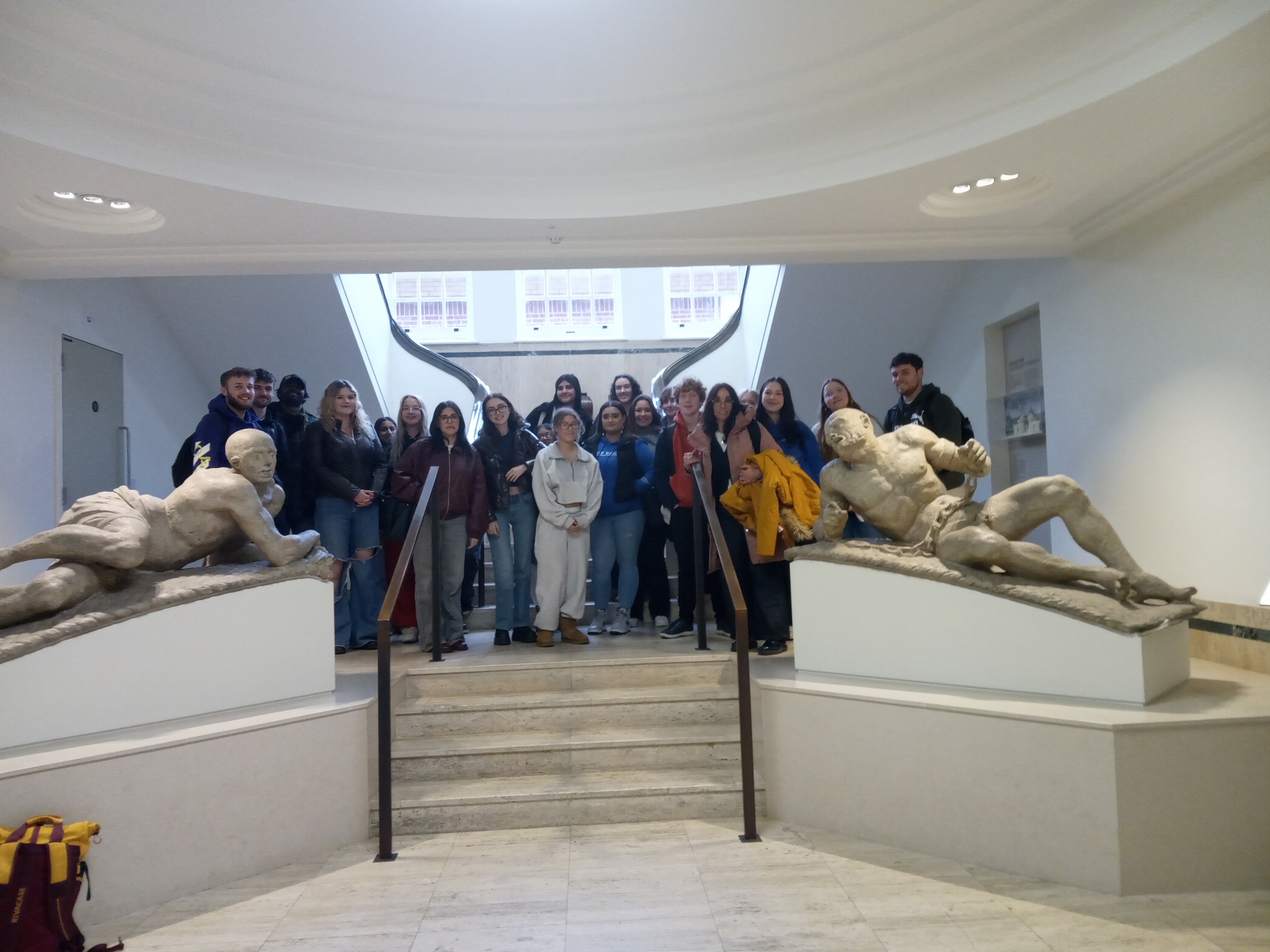 A group of students stand in a museum lobby