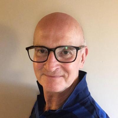 A smiling man wearing glasses